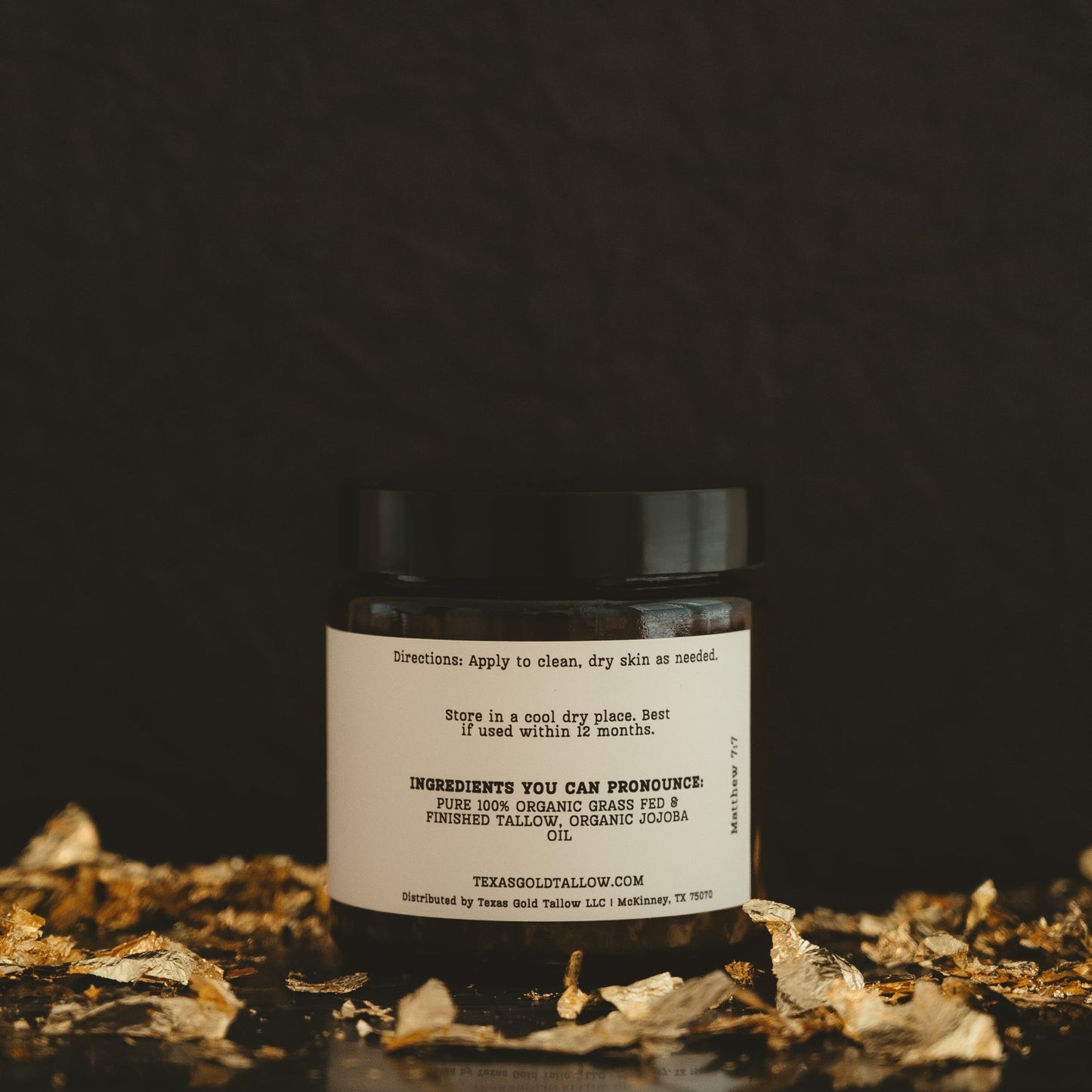 Texas Gold tallow unscented Grass fed and grass finished beef tallow balm Back of the Jar with a black background and gold flakes
