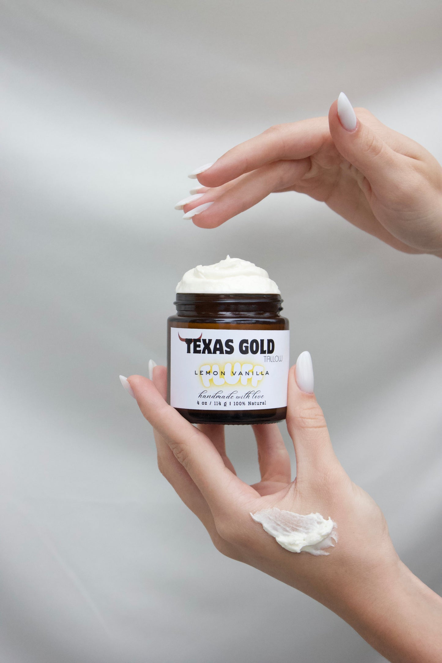 texas gold tallow whipped grass fed and grass finished tallow fluff hand dipping with swatch on hand showing texture
