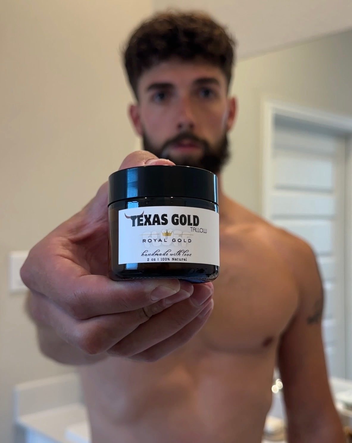 Man holding Texas Gold Tallow Royal Gold FLUFF, man using beef tallow for his beard and skincare