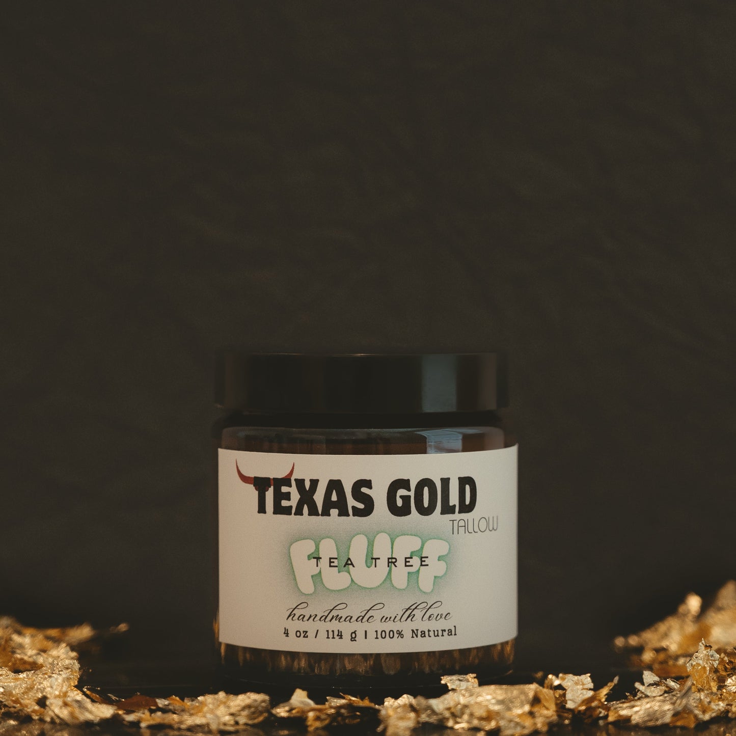 Texas Gold Tallow Tea Tree FLUFF in 4oz glass jar with black background and gold flakes