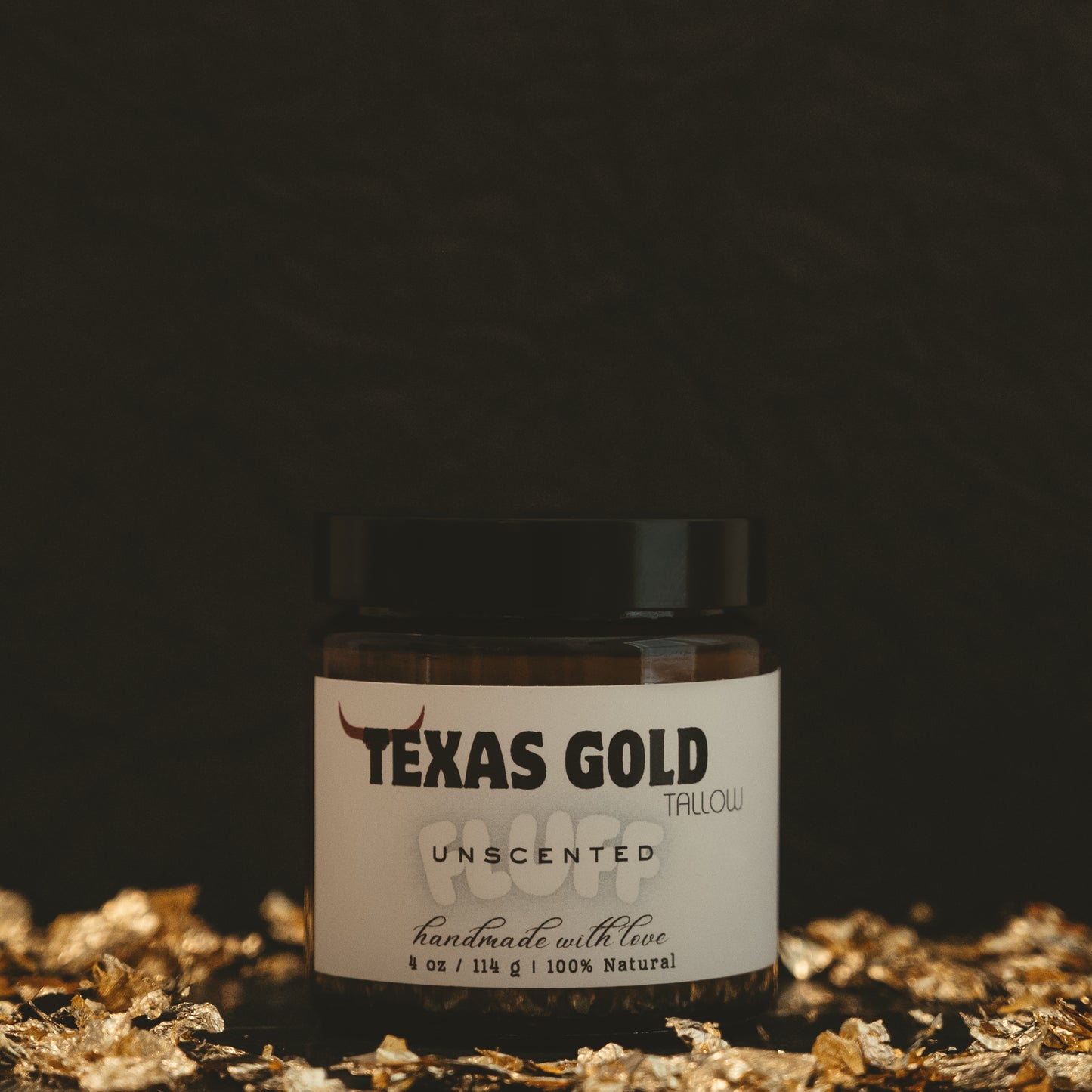Texas Gold Tallow Unscented FLUFF in a 4oz glass jar with black background and gold flakes.
